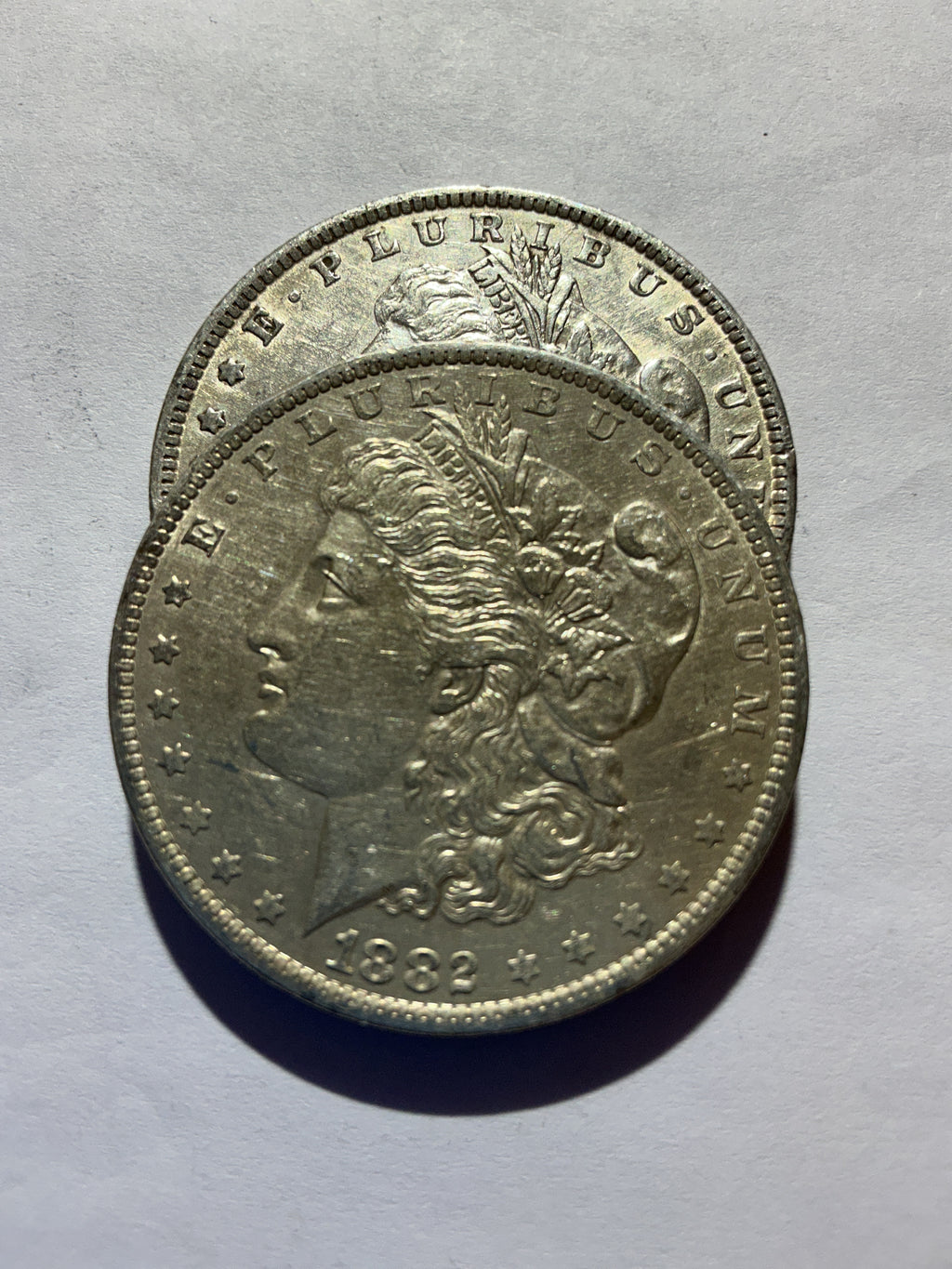 Lot 44, 2 1882 O Morgan silver dollar, AU