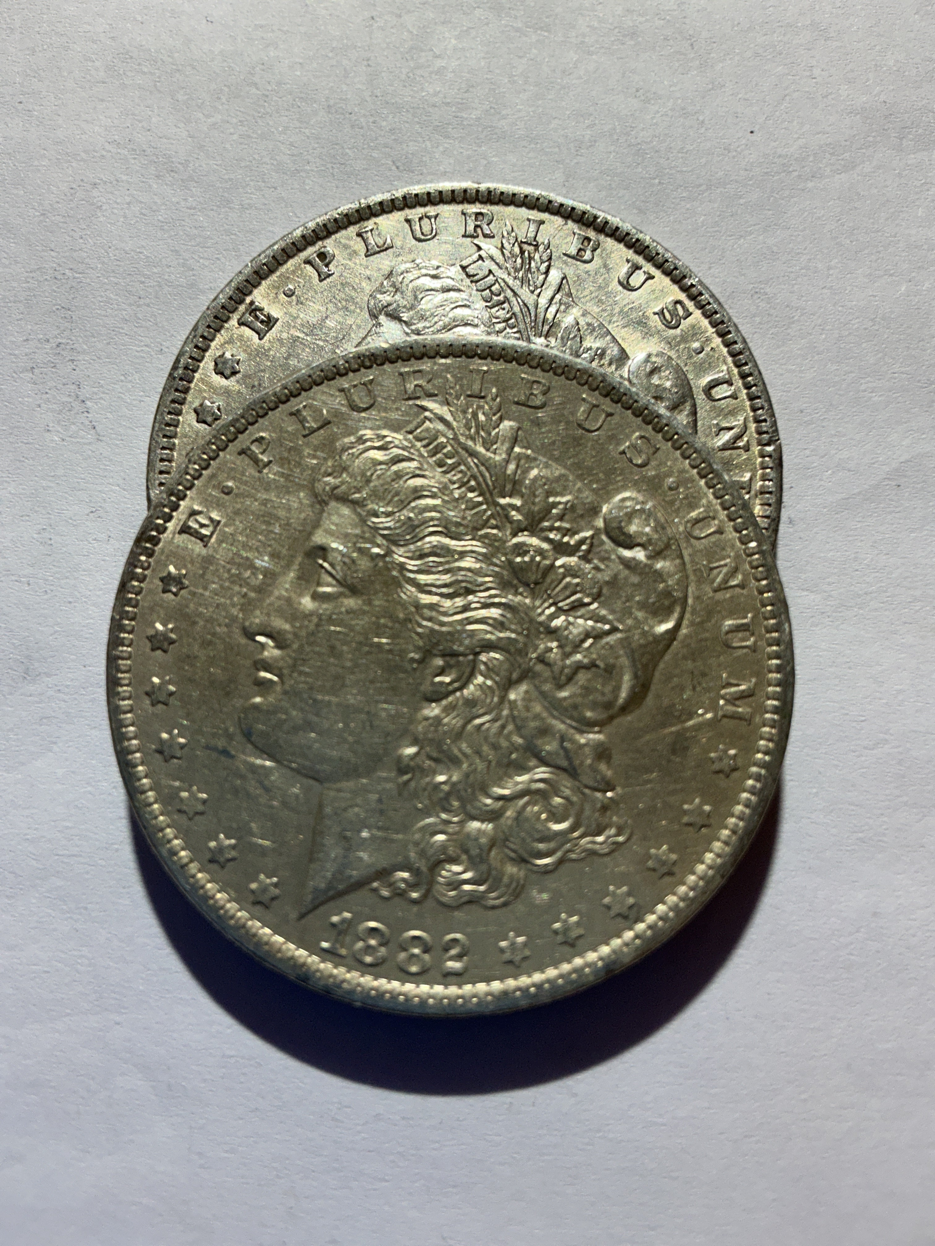 Lot 44, 2 1882 O Morgan silver dollar, AU