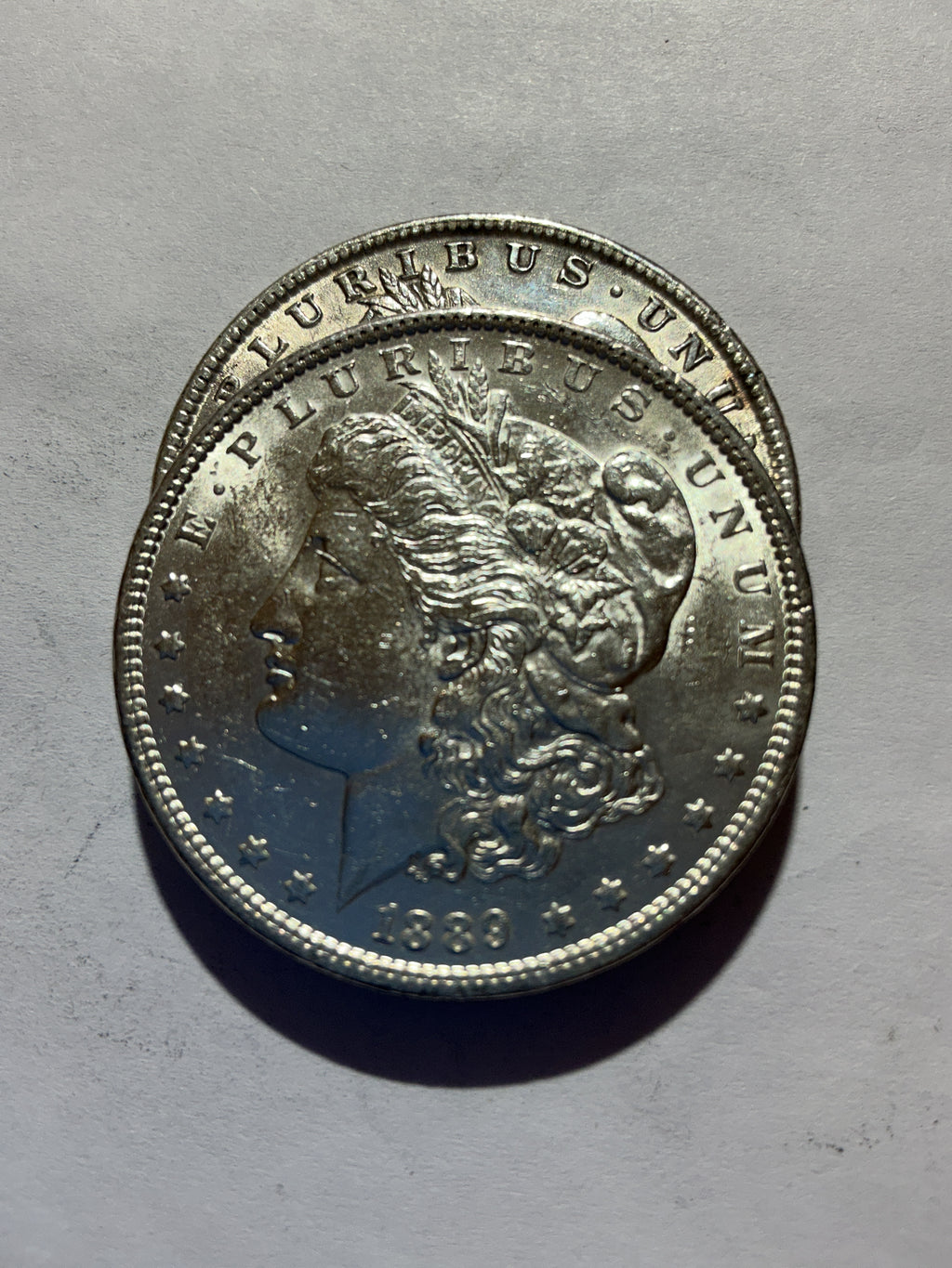 Lot 56, 2 1889 Morgan silver dollar, AU