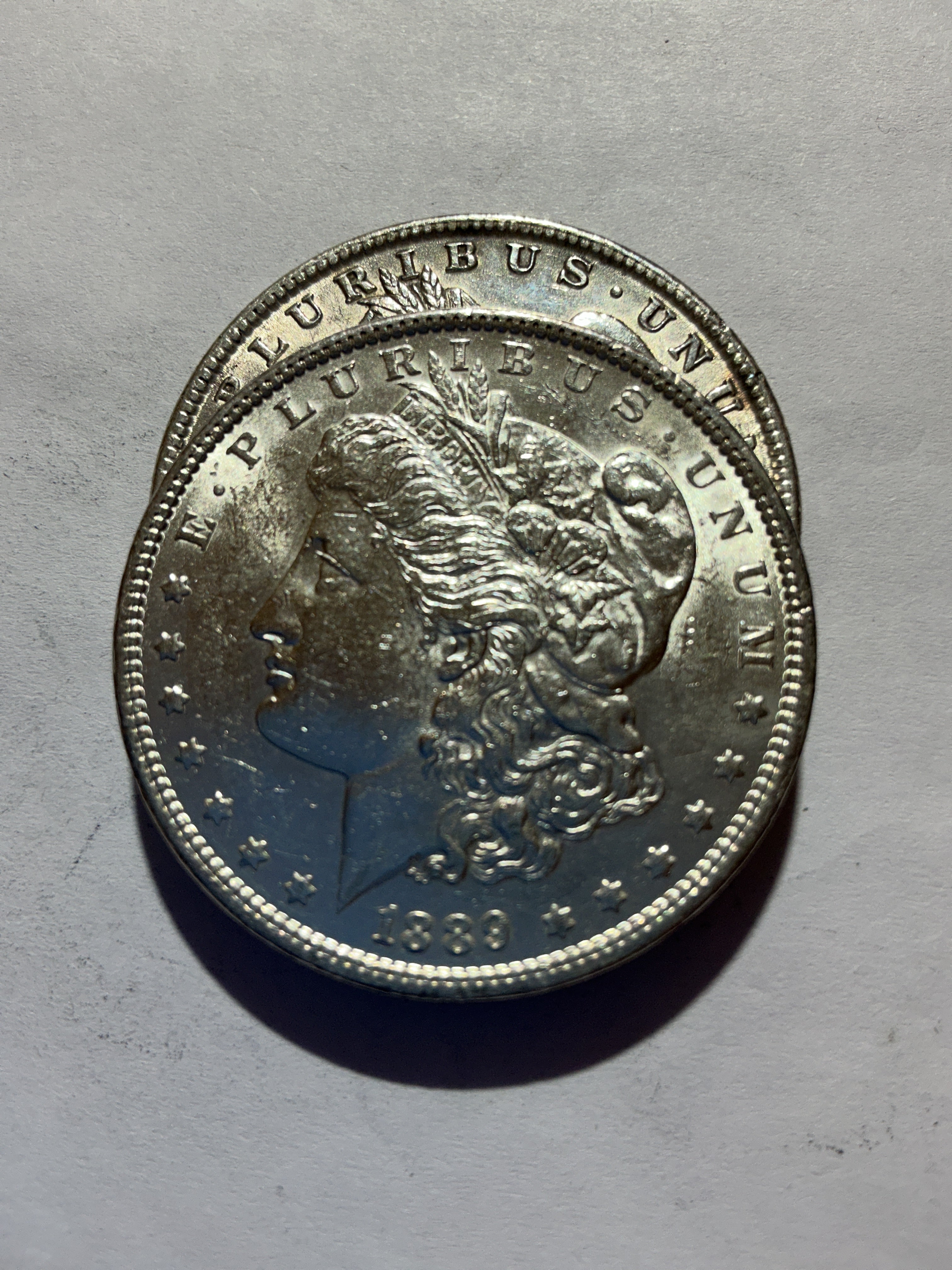 Lot 56, 2 1889 Morgan silver dollar, AU