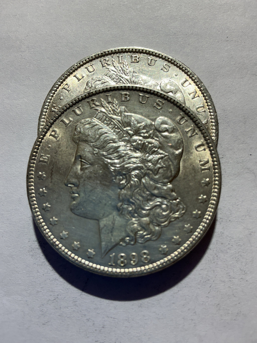 Lot 60, 2 1898 Morgan silver dollar, AU