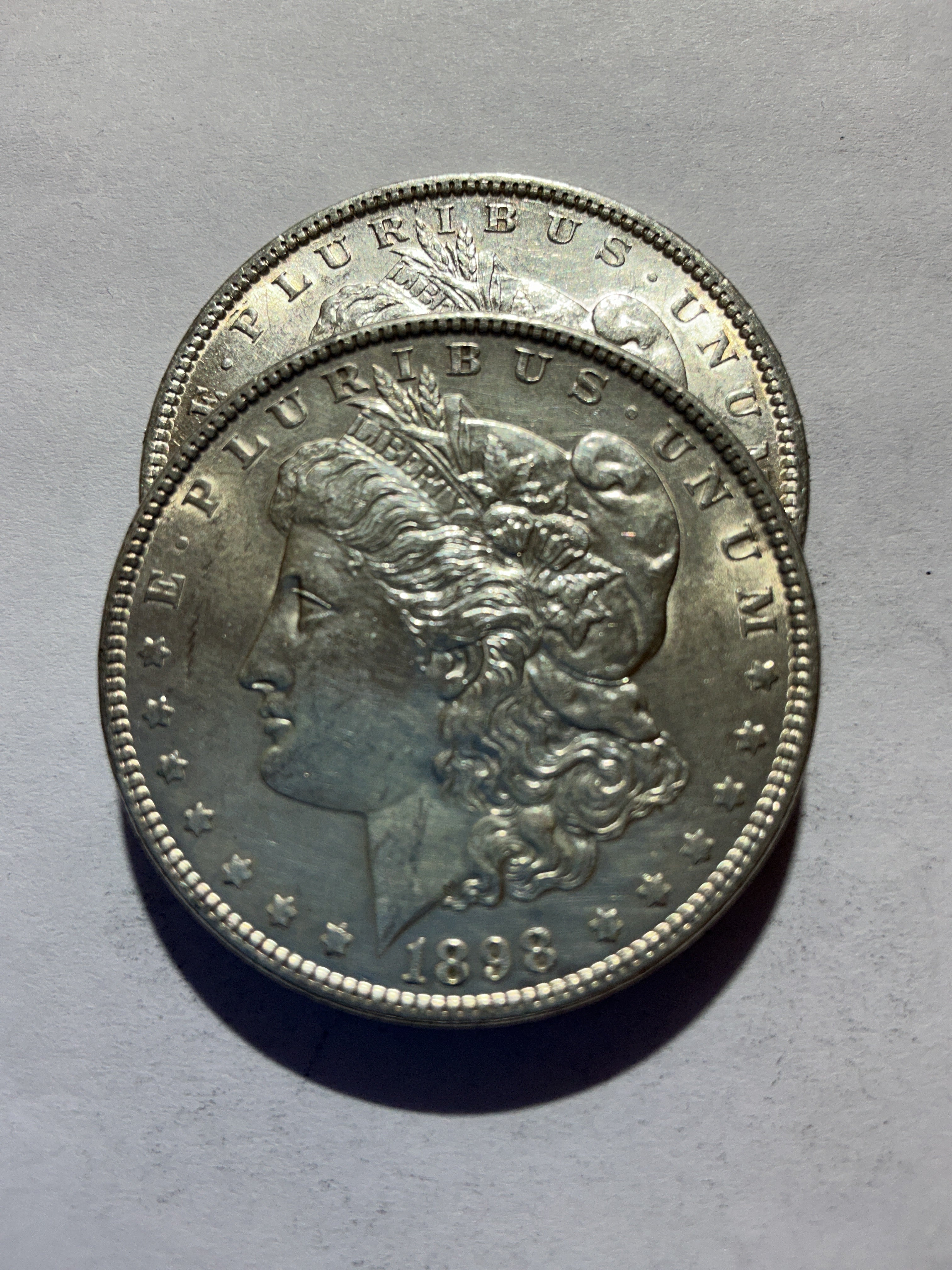 Lot 60, 2 1898 Morgan silver dollar, AU