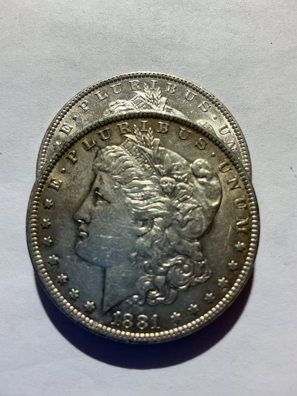 Lot 43, 2 1881 O Morgan silver dollar, AU
