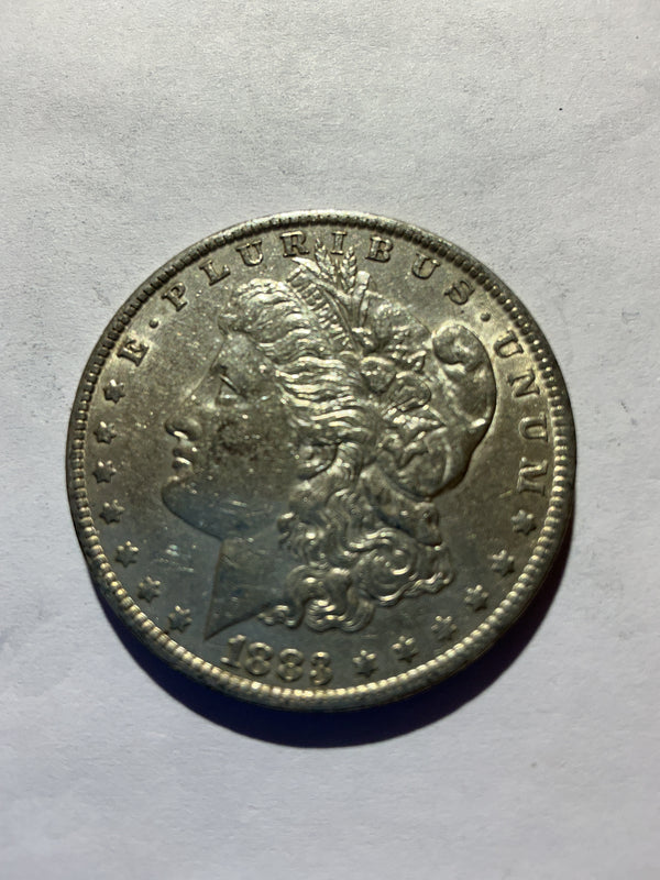 Lot 48, 1883 O Morgan silver dollar, AU