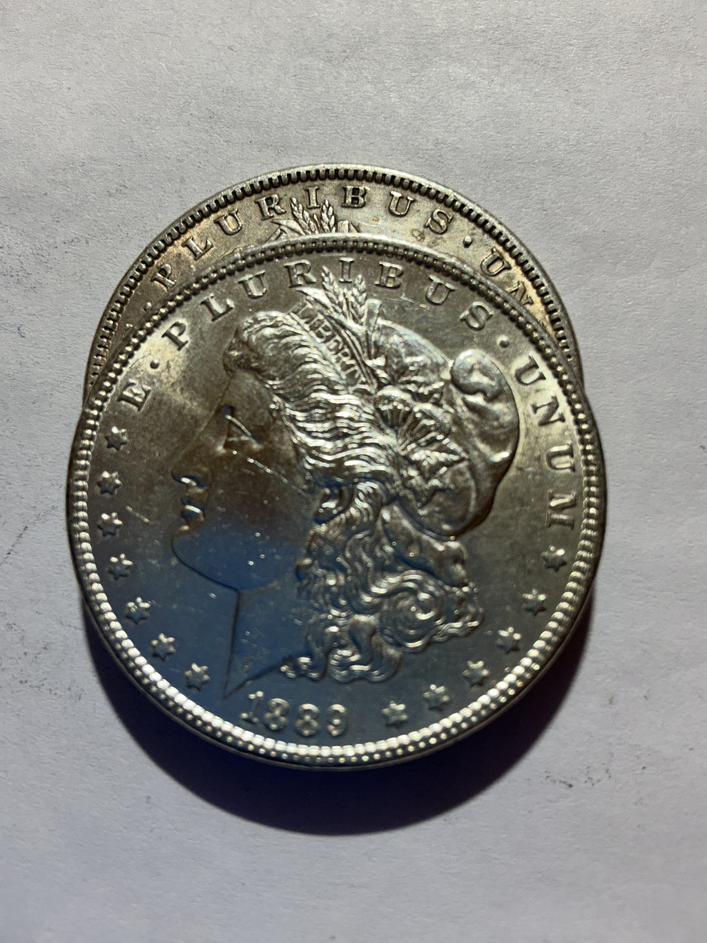 Lot 55, 2 1889 Morgan silver dollar, AU