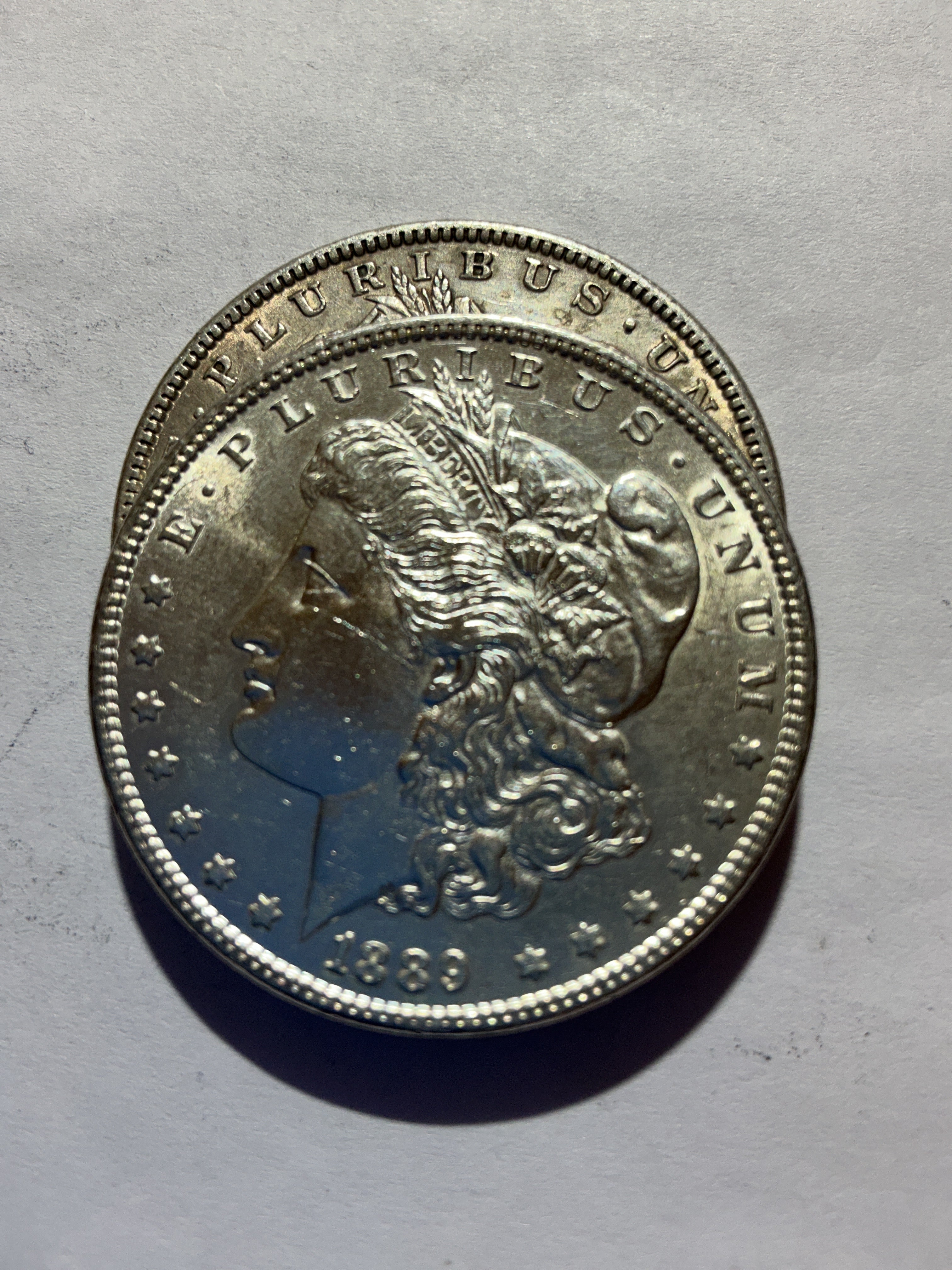 Lot 55, 2 1889 Morgan silver dollar, AU