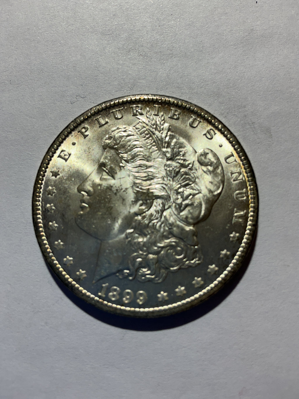Lot 77, 1899 O Morgan silver dollar, BU
