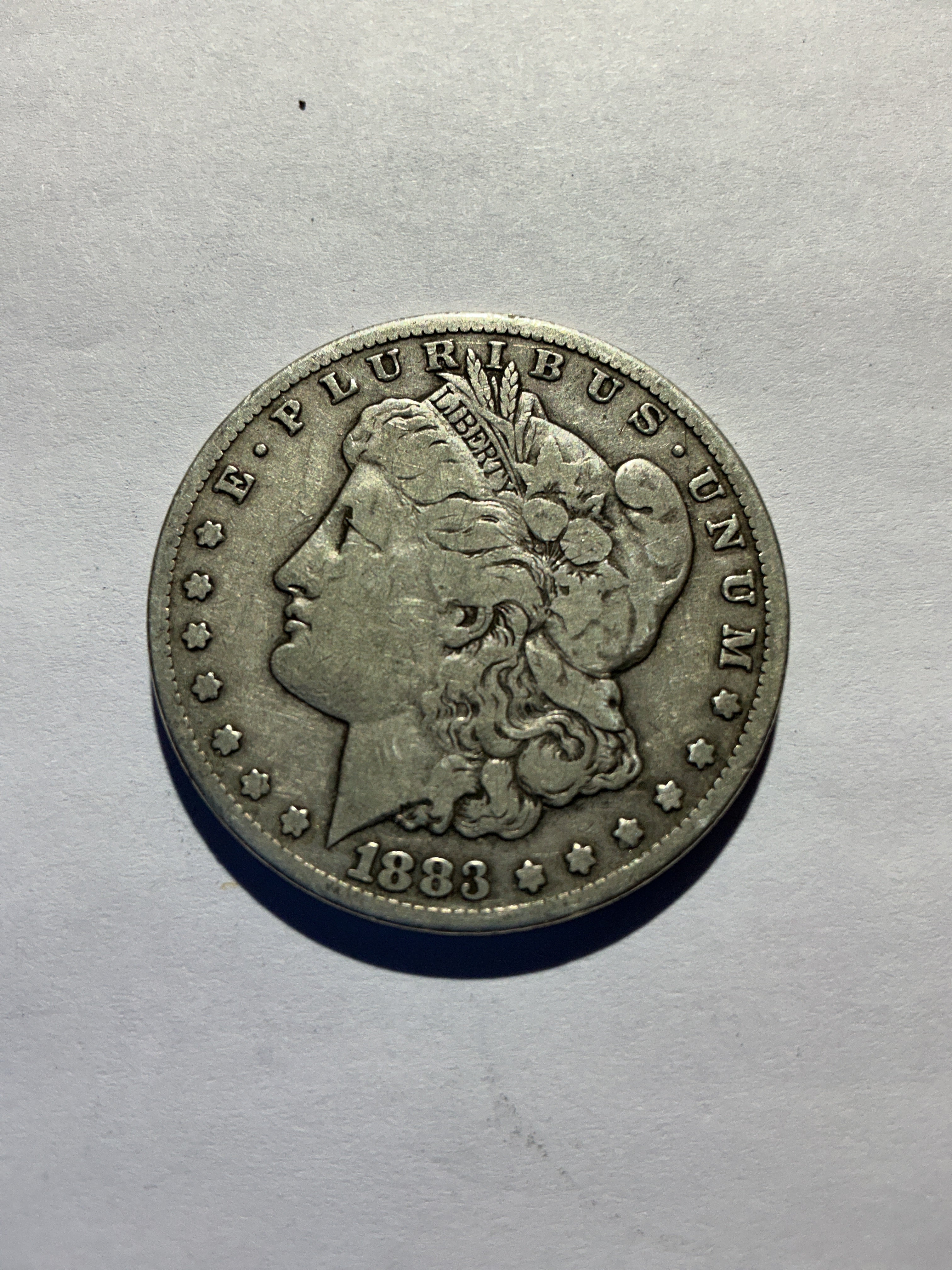 Lot 9, 1883 CC Morgan silver dollar, F+