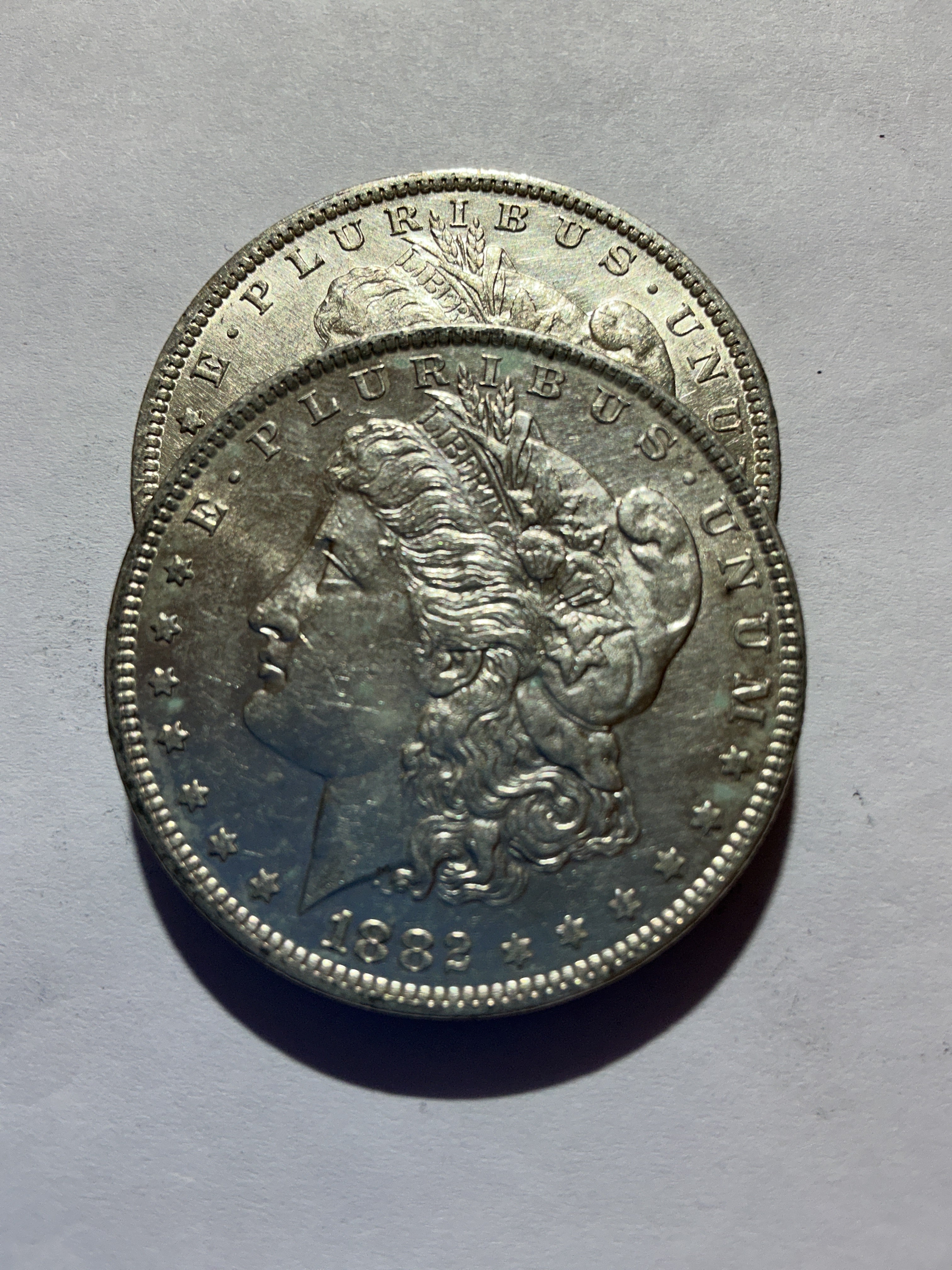 Lot 45, 2 1882 O Morgan silver dollar, AU