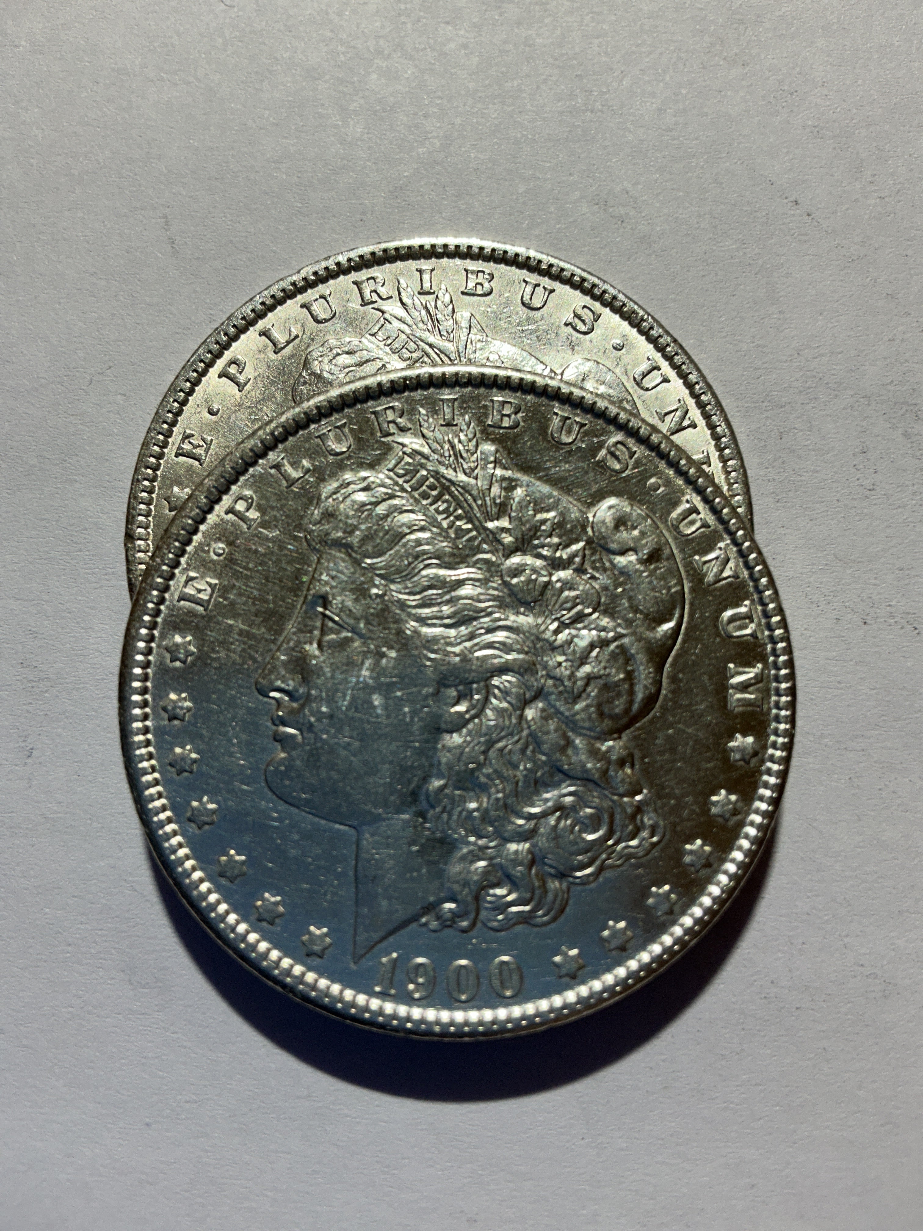 Lot 18, 2 1900 Morgan silver dollar, AU