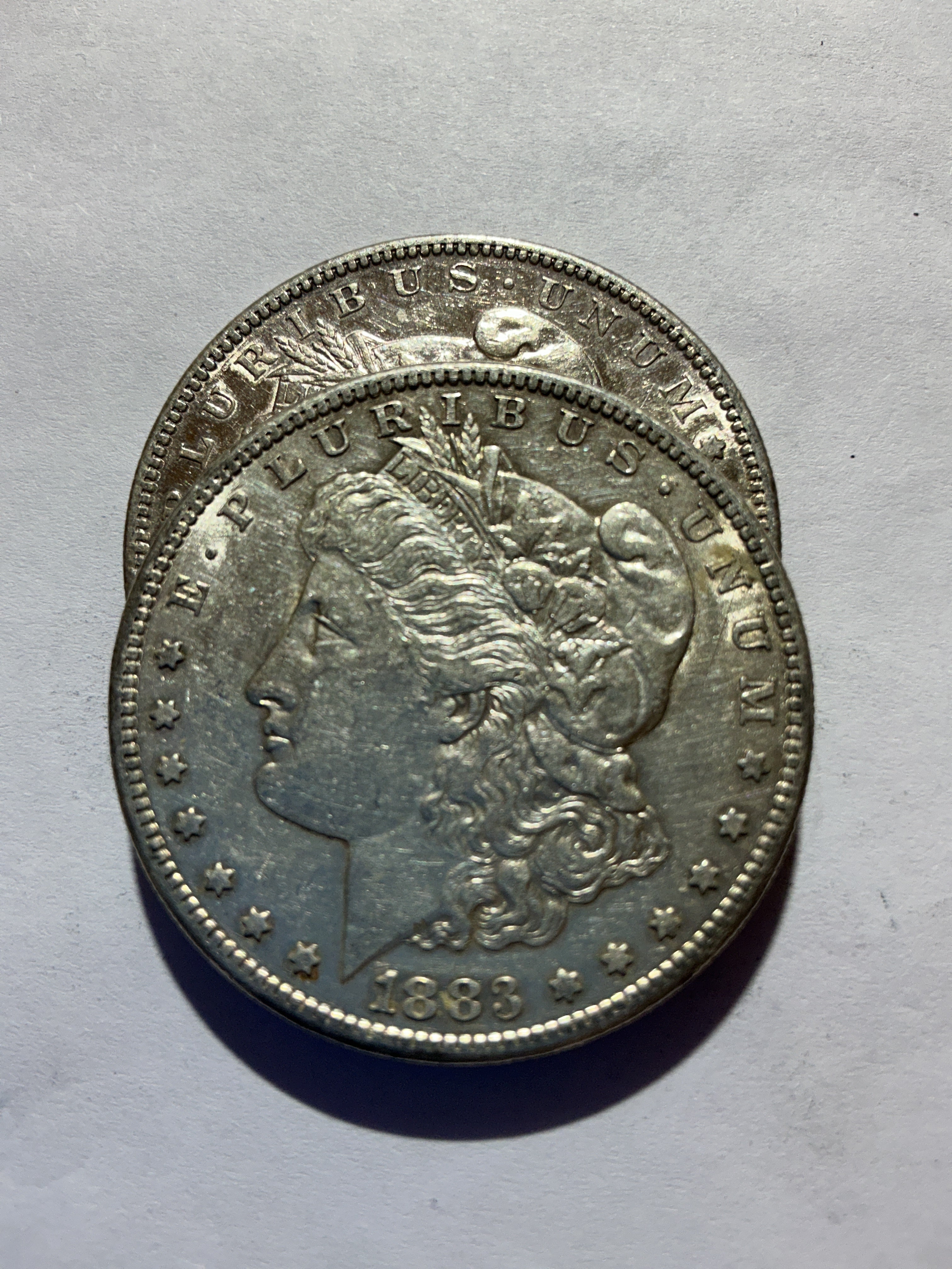 Lot 46, 2 1883 S Morgan silver dollar, AU