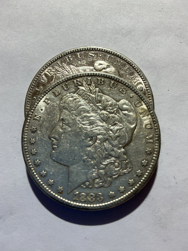 Lot 46, 2 1883 S Morgan silver dollar, AU